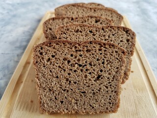 homemade rye bread on sourdough sliced on a wooden board 