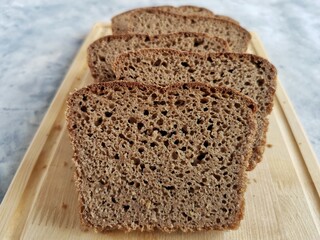 homemade rye bread on sourdough sliced on a wooden board 