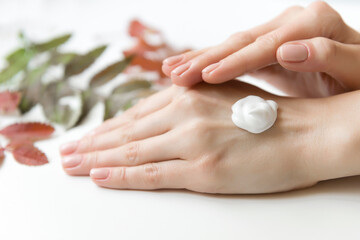 Dry touch hand moisturizing cream on woman's hands