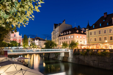 The promenade on the Ljubljanica river in the slovenian capital city Ljubljana with the Triple...