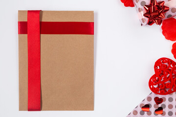 Valentines craft envelope mockup, flat lay with pink gifts, red ribbons and hearts. Birthday, Mothers day, Valentines day