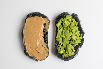 Black bread toast with peanut butter and avocado