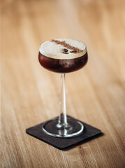 Espresso cocktail with coffee beans served on table