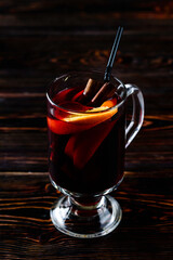 Mulled wine and spices on wooden background. Selective focus.