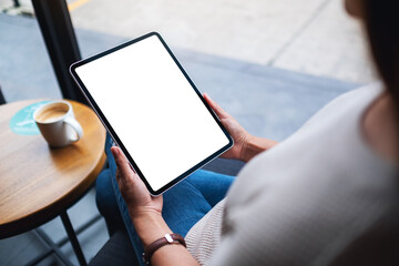 Mockup image of a woman holding digital tablet with blank white desktop screen