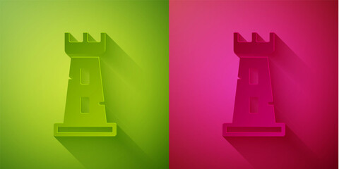 Paper cut Castle tower icon isolated on green and pink background. Fortress sign. Paper art style. Vector.