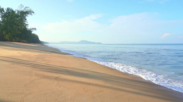Slow motion of exotic sea waves breaking on a hidden empty sandy tropical beach. Static full frame
