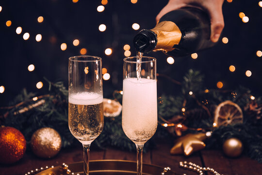 Champagne is poured into a glass on Christmas night