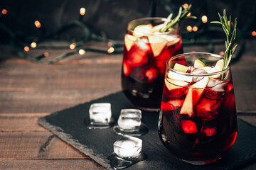  Two glasses of sangria with ice. Red wine with apples and spices, photo with copy space