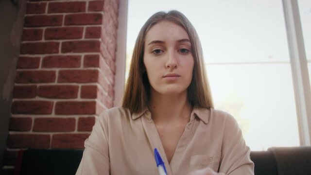 Teen girl school college student study distance learning talk with online teacher on laptop screen write notes. Elearning zoom video call, video conference class with tutor.