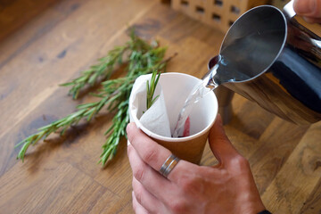 Black tea with jam and rosemary in a paper cup