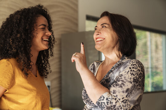 Happy Latin American Mother And Daughter Talking