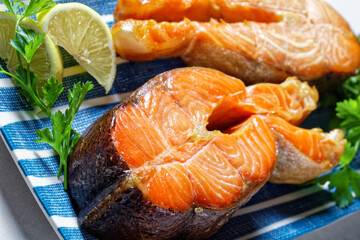 salmon steaks on a blue plate, top view