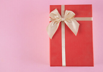 Gift box on an isolated pink background. Rectangular gift box.