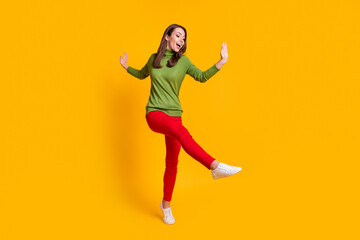 Fototapeta na wymiar Full length body size view of pretty skinny cheerful girl jumping dancing having fun clubbing isolated shine yellow color background