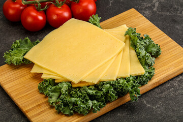 Sliced Gauda cheese over board