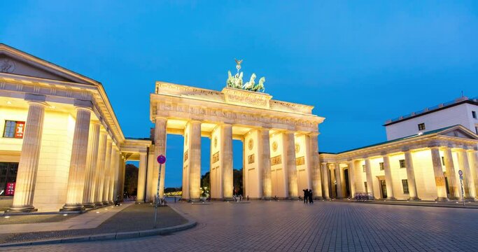 Night to day hyper lapse of the Brandenburg gate in Berlin with red sunrise reflecting