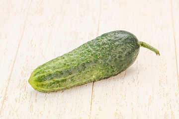 Green ripe fresh cucumber over background