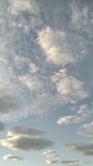 Light blue sky with different textured clouds.
Autumn sunny evening. Blue sky in the sky white small clouds evenly cover the entire space. Clouds of different shapes and textures. Feeling of calmness 