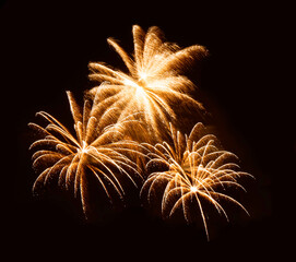 Golden orange amazing fireworks isolated in dark background close up with the place for text, Malta...