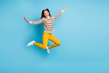 Full length photo of adorable sweet young woman dressed ornament pullover jumping copyspace isolated blue color background