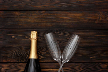 Obraz na płótnie Canvas Champagne as New Year symbol on dark wooden background top view