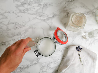 Caucasian female making homemade zero waste, ecological and multipurpose detergent for laundry or...