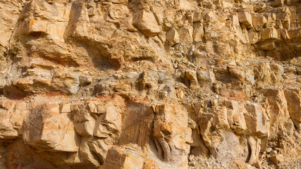 Stony slope of a sheer cliff. Textured background.
