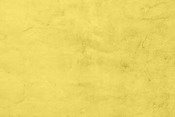 Pastel olored yellow colored low contrast Concrete textured background with roughness and irregularities. 2021 color trend.