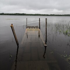 Naklejka premium flooded half bridge by the lake