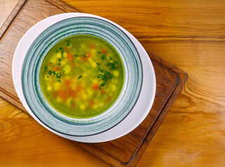 Russian soup in a plate on a wooden table