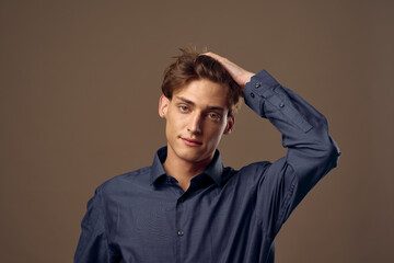 Fototapeta premium elegant man in shirt holds hand on head studio 