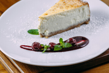 dessert cake on white plate and wooden table