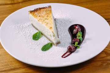 dessert cake on white plate and wooden table