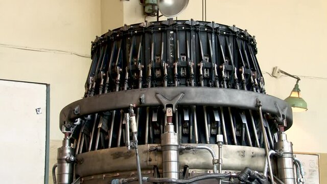 Repair of gas turbine engines with afterburner.  Checking operability of control system of shutters of jet nozzle of aircraft engine on stand in factory. Close-up. Aircraft engines. 
