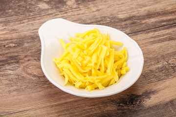 Shredded yellow cheese in the bowl