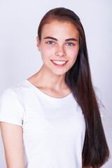 Fototapeta premium Close up portrait of a young beautiful happy brunette girl