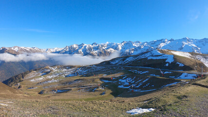 Snow and mountain peaks in the french Pyrenees near the Luchon Superbagnères Ski Resort in the Arrondissement of Saint-Gaudens, Occitania, Haute-Garonne, France. The Luchonnais Mountains aerial view.