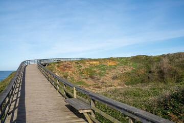 Fototapeta na wymiar wooden boardwalk and coast at the Playa de las Catedrales national monument in Galicia