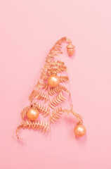 Christmas tree of painted golden leaves fern on pink paper background