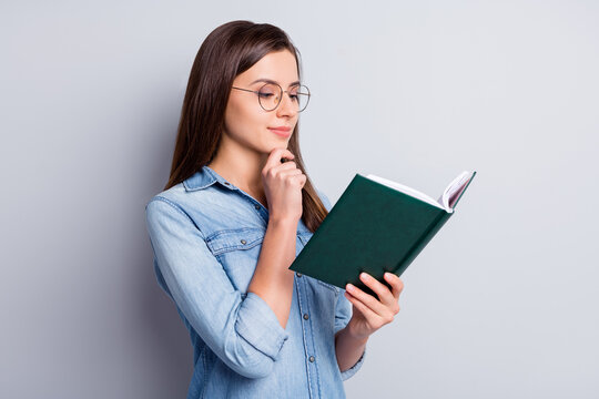 Photo of cute sweet long brunette hairdo girl hand chin read planner wear spectacles blue cloth isolated on grey background