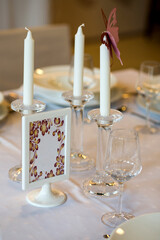 Wedding table details with candles and glasses