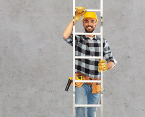 profession, construction and building concept - happy smiling male worker or builder in helmet and gloves climbing up ladder over grey concrete background © Syda Productions