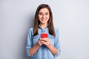 Photo of charming person hold phone good mood read nice comments eyewear isolated on grey color background