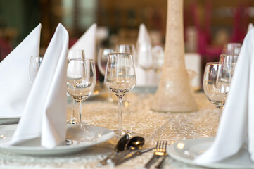 Beautiful table decoration detail inside a restaurant prepared for a wedding reception.