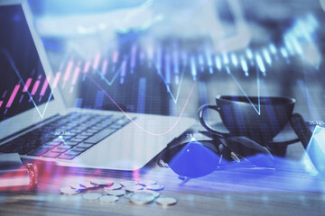 Financial chart drawing and table with computer on background. Double exposure. Concept of...