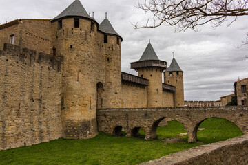 Fototapeta na wymiar The Château Comtal - entrance from the Cité of Carcassonne, France. The chateau of the Counts of Carcassonne and the ramparts, a UNESCO World Heritage site located at the heart of the fortified city.