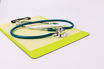 Blue stethoscope on  Yellow Paper Note