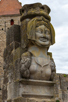 The bust of the famous Dame Carcass (reproduction of the original statue) and Narbonne tower. The legend of Lady Carcas is an etiological story about the origin of Carcassonne's name, France.