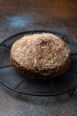 Homemade dark chocolate cake with shredded almond and desiccated coconut topping